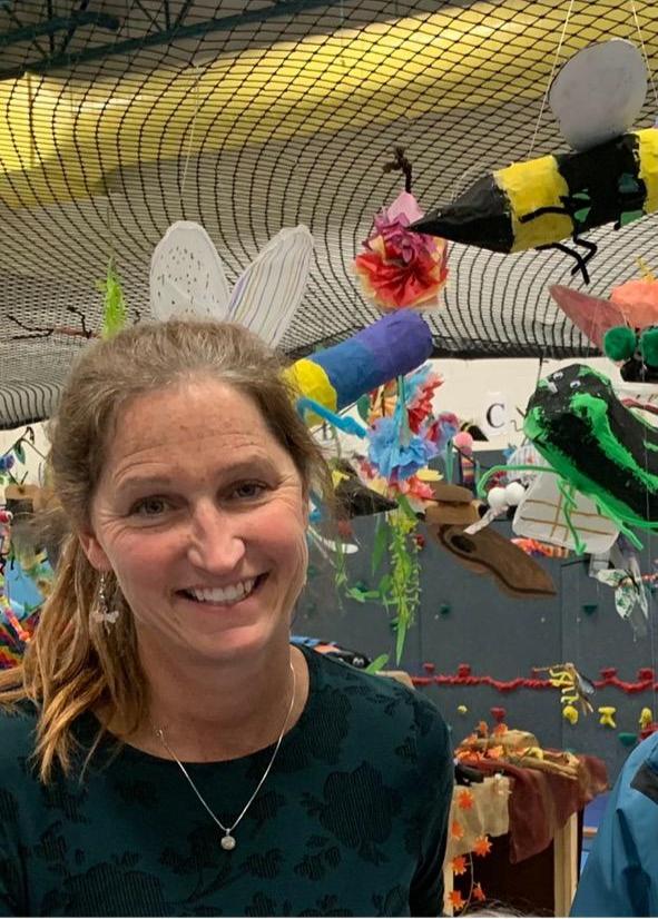 Pike poses in front of her students tropical rainforest display!