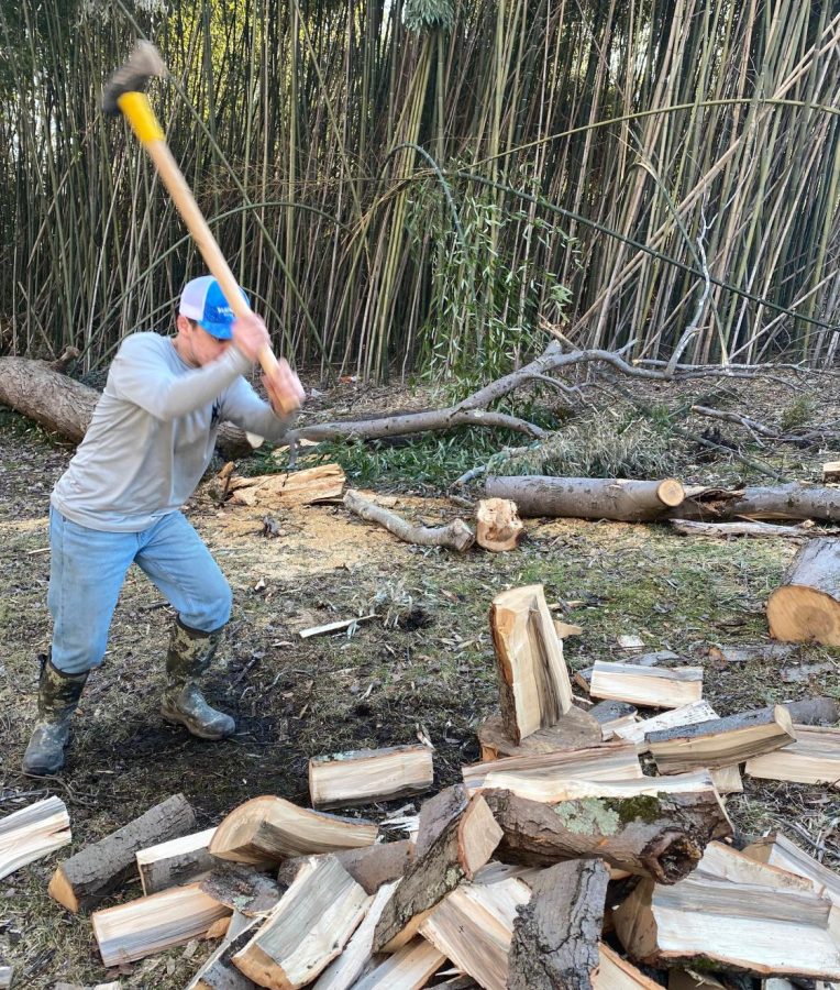 Robert Whitley splitting wood on a job site in Huntingtown Maryland.