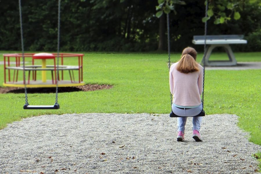 Sad girl on a swing. Free public domain CC0 photo.